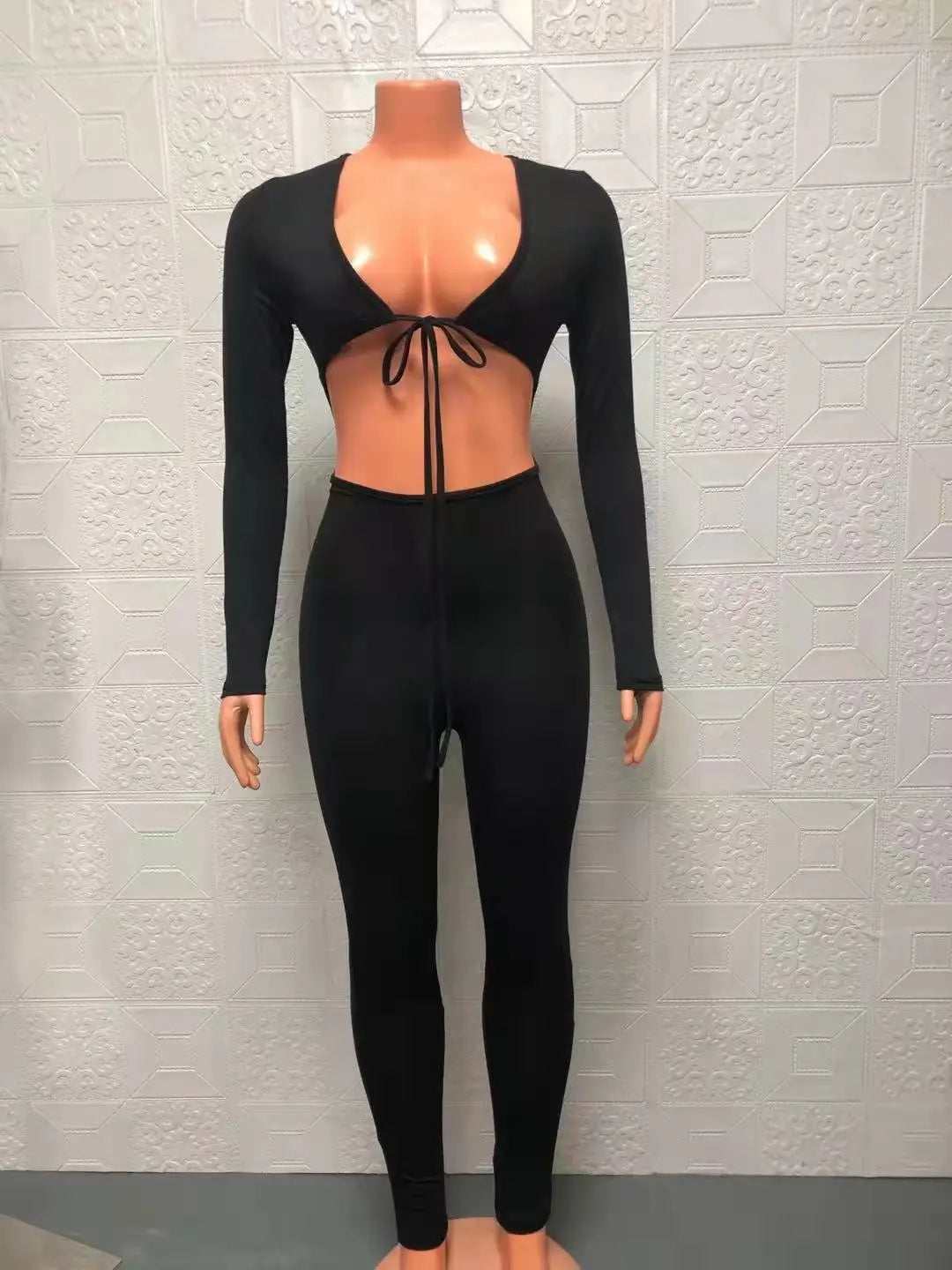 Fashionable new solid color tight fitting sexy exposed navel lace up hollow long sleeved slim fit jumpsuit